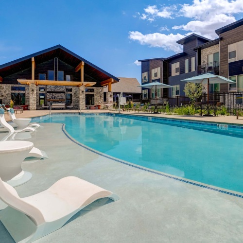 Resort-style swimming pool with lounge seating Resort-style swimming pool with lounge seating